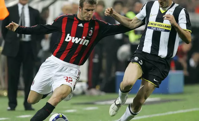 FILE - AC Milan English soccer star David Beckham, left, challenges for the ball with Juventus defender Giorgio Chiellini during the Serie A soccer match between AC Milan and Juventus at the San Siro stadium in Milan, Italy, Sunday, May 10, 2009. (AP Photo/Antonio Calanni, File)