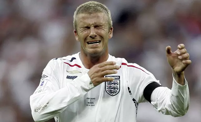 FILE - England's soccer star David Beckham reacts after he missed a free-kick and hit the goalpost during an exhibition soccer match against Brazil, at Wembley Stadium in London, June 1, 2007. (AP Photo/Alastair Grant, File)