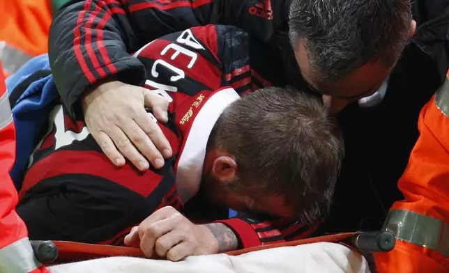 FILE - AC Milan English soccer star David Beckham leaves the pitch after being injured during the Serie A soccer match between AC Milan and Chievo at the San Siro stadium in Milan, Italy, Sunday, March 14, 2010. (AP Photo/Antonio Calanni, File)