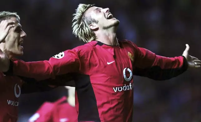 FILE - Manchester United's David Beckham, right, celebrates his goal against Zalaegerszeg of Hungary with teammate Philip Neville, left, during their UEFA Champions League qualifying match in Manchester, England, Aug. 27, 2002. (AP Photo/Max Nash, FIle)