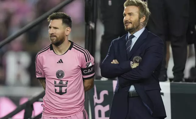 FILE - Inter Miami forward Lionel Messi, left, stands with co-owner David Beckham, right, during a ceremony for the team winning the Supporters' Shield after an MLS soccer match against the New England Revolution, Saturday, Oct. 19, 2024, in Fort Lauderdale, Fla. (AP Photo/Lynne Sladky, File)