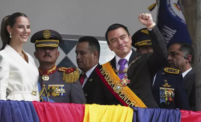 Ecuador's President Daniel Noboa and his wife, Lavinia Valbonesi, acknowledge supporters from the balcony of the presidential palace after his swearing-in ceremony for a second term in Quito, Ecuador, Saturday, May 24, 2025. (AP Photo/Carlos Noriega)