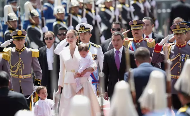 Ecuador's President Daniel Noboa, accompanied by his wife Lavinia Valbonesi and their two children, arrives at the National Assembly for his swearing-in ceremony for a second term, in Quito, Saturday, May 24, 2025. (AP Photo/Dolores Ochoa)
