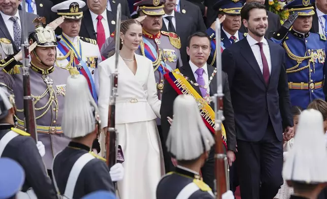 Ecuador's President Daniel Noboa walks out of the National Assembly with his wife, Lavinia Valbonesi, and National Assembly President Niels Olsen, right, after his swearing-in ceremony for a second term, in Quito, Ecuador, Saturday, May 24, 2025. (AP Photo/Dolores Ochoa)