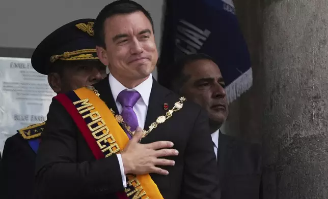Ecuador's President Daniel Noboa acknowledges supporters from the balcony of the presidential palace after his swearing-in ceremony for a second term in Quito, Ecuador, Saturday, May 24, 2025. (AP Photo/Carlos Noriega)