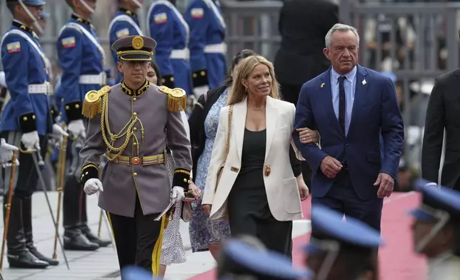U.S. Secretary of Health and Human Services Robert Kennedy Jr. and his wife Cheryl Hines arrive for the swearing-in ceremony for a second term of Ecuador's President Daniel Noboa at the National Assembly in Quito, Ecuador, Saturday, May 24, 2025. (AP Photo/Dolores Ochoa)