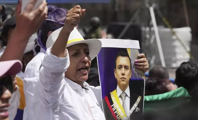 A supporter of Ecuador's President Daniel Noboa cheers as he appears on the balcony of the presidential palace after his swearing-in ceremony for a second term in Quito, Ecuador, Saturday, May 24, 2025. (AP Photo/Carlos Noriega)