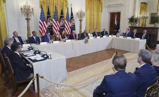 President Donald Trump, seated and center, listens during a Make America Healthy Again (MAHA) Commission Event in the East Room of the White House, Thursday, May 22, 2025, in Washington. (AP Photo/Jacquelyn Martin)