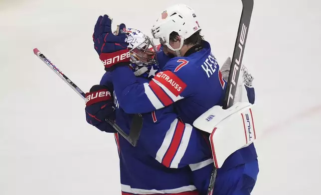 United States' goalkeeper Jeremy Swayman and Michael Kesselring celebrate after the semifinal match between Sweden and the United States at the ice hockey world championships in Stockholm,Sweden, Saturday, May 24, 2025. (AP Photo/Petr David Josek)