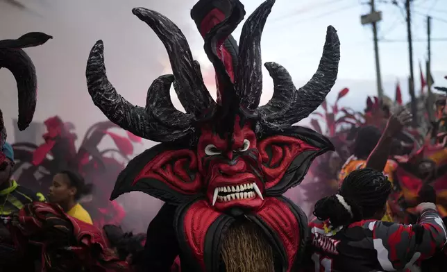 Revelers take part in the Devils and Congos Festival in Portobelo, Panama, Saturday, May 3, 2025. (AP Photo/Matias Delacroix)