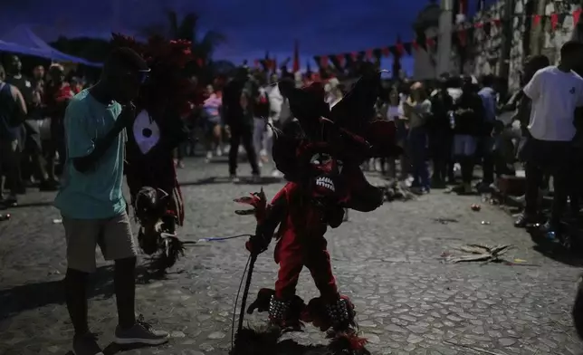 Revelers take part in the Devils and Congos Festival in Portobelo, Panama, Saturday, May 3, 2025. (AP Photo/Matias Delacroix)