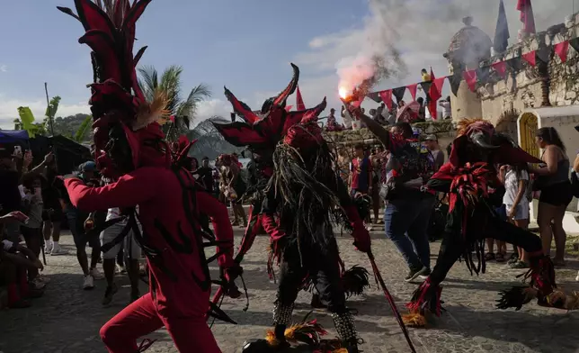 Revelers take part in the Devils and Congos Festival in Portobelo, Panama, Saturday, May 3, 2025. (AP Photo/Matias Delacroix)