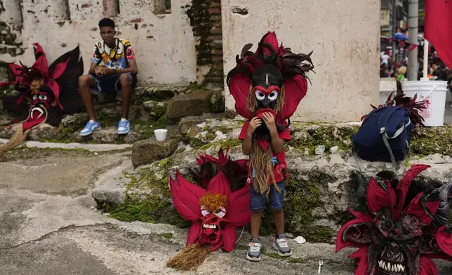 Revelers take part in the Devils and Congos Festival in Portobelo, Panama, Saturday, May 3, 2025. (AP Photo/Matias Delacroix)