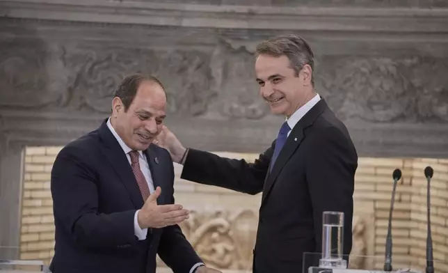 Greece's Prime Minister Kyriakos Mitsotakis, right, and Egyptian President Abdel-Fattah el-Sissi gesture during a joint news conference in Athens, on Wednesday, May 7, 2025. (AP Photo/Petros Giannakouris)