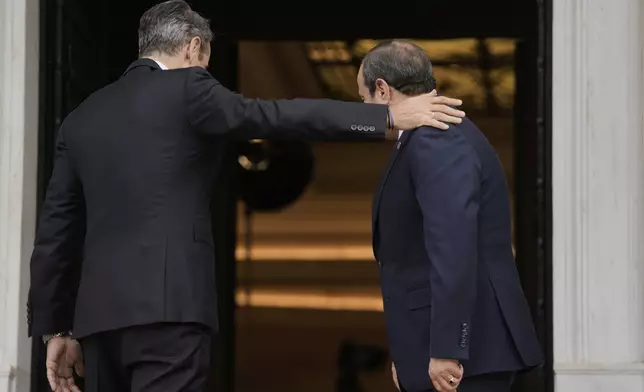 Greece's Prime Minister Kyriakos Mitsotakis, left, welcomes Egyptian President Abdel-Fattah el-Sissi prior their meeting in Athens, on Wednesday, May 7, 2025. (AP Photo/Petros Giannakouris)