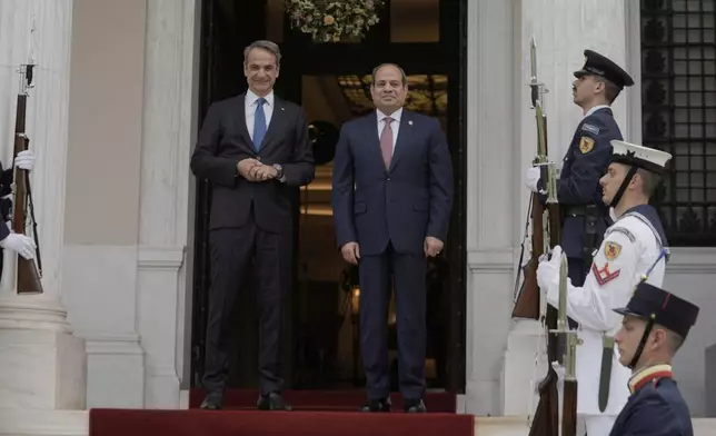 Greece's Prime Minister Kyriakos Mitsotakis, left, and Egyptian President Abdel-Fattah el-Sissi pose for photographs prior their meeting in Athens, on Wednesday, May 7, 2025. (AP Photo/Petros Giannakouris)