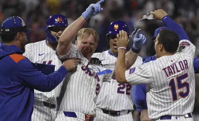 New York Mets players celebrate after defeating the Pittsburgh Pirates in a baseball game Monday, May 12, 2025, in New York. (AP Photo/Pamela Smith)