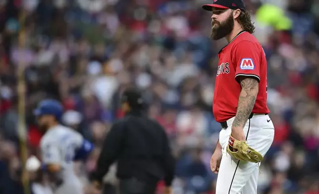 Cleveland Guardians relief pitcher Hunter Gaddis waits for Los Angeles Dodgers' Michael Conforto to run the bases after hitting a solo home run during the sixth inning of a baseball game, Tuesday, May 27, 2025, in Cleveland. (AP Photo/David Dermer)