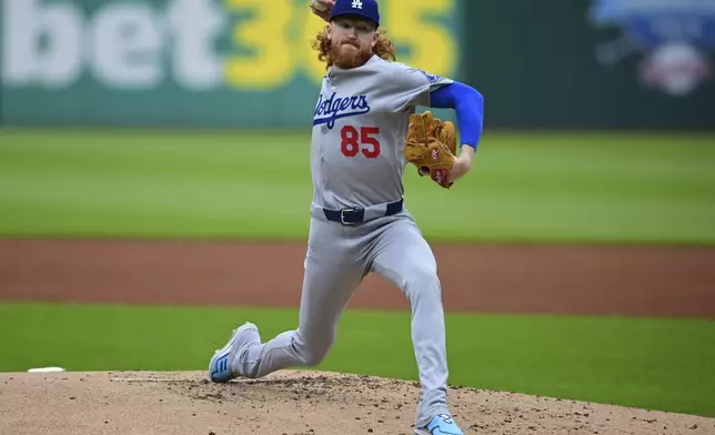 Los Angeles Dodgers starting pitcher Dustin May delivers during the first inning of a baseball game against the Cleveland Guardians, Tuesday, May 27, 2025, in Cleveland. (AP Photo/David Dermer)