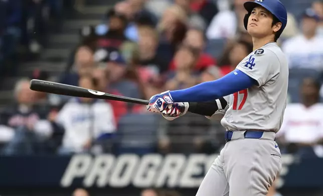 Los Angeles Dodgers' Shohei Ohtani watches his ball after hitting a two run home run off Cleveland Guardians starting pitcher Tanner Bibee during the fourth inning of a baseball game, Tuesday, May 27, 2025, in Cleveland. (AP Photo/David Dermer)