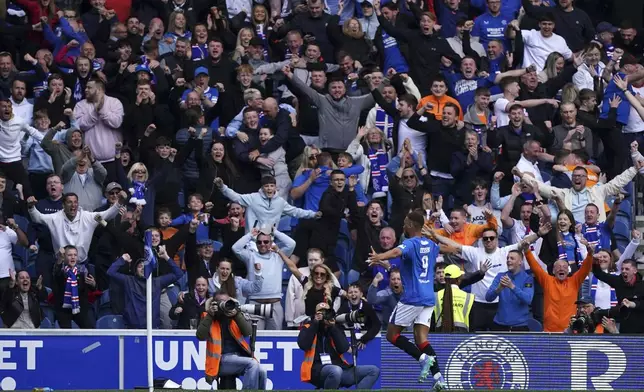 Rangers' Cyriel Dessers celebrates scoring their side's first goal of the game during the Scottish Premiership soccer match between Rangers and Celtic at Ibrox Stadium, Glasgow, Scotland, Sunday, May 4, 2025. (Steve Welsh/PA via AP)