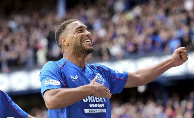 Rangers' Cyriel Dessers celebrates scoring their side's first goal of the game during the Scottish Premiership soccer match between Rangers and Celtic at Ibrox Stadium, Glasgow, Scotland, Sunday, May 4, 2025. (Steve Welsh/PA via AP)