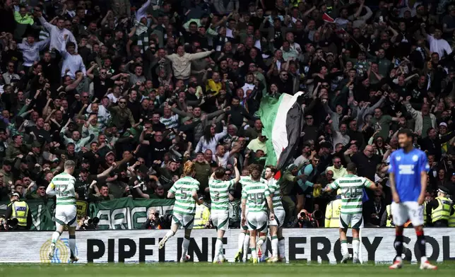 Celtic players celebrate after Adam Idah scores their first goal during the Scottish Premiership soccer match between Rangers and Celtic at Ibrox Stadium, Glasgow, Scotland, Sunday, May 4, 2025. (Steve Welsh/PA via AP)