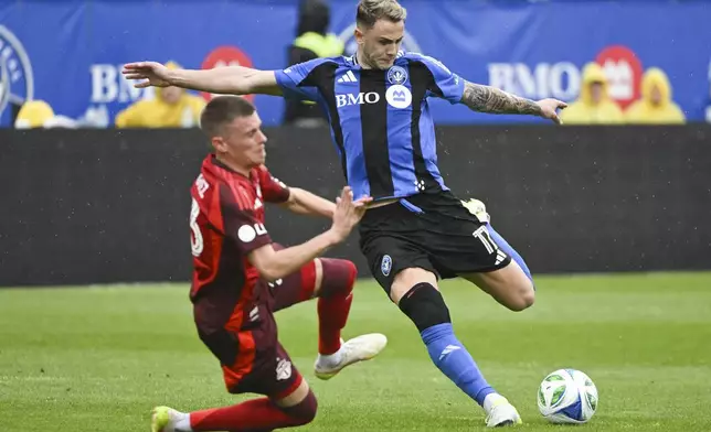 Toronto FC's Maxime Dominguez, left, tries to block CF Montreal's Giacomo Vrioni (17) as he takes a shot at goal during the first half of a MLS soccer game in Montreal, Saturday, May 17, 2025. (Graham Hughes/The Canadian Press via AP)