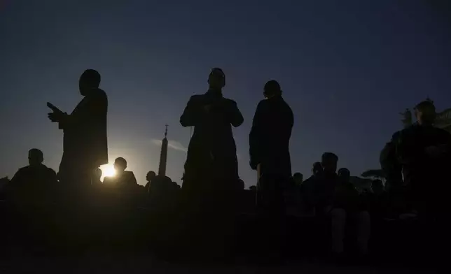 People gather to attend Pope Leo XIV's formal inauguration of his pontificate with a Mass in St. Peter's Square attended by heads of state, royalty and ordinary faithful, Sunday, May 18, 2025. (AP Photo/Alessandra Tarantino)