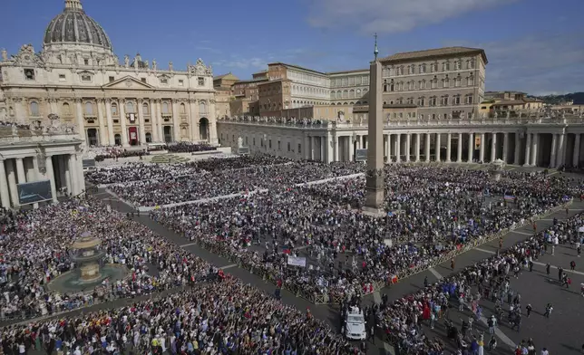 Pope Leo XIV on his popemobile, bottom, tours St. Peter's Square at the Vatican prior to the inaugural Mass of his pontificate, Sunday, May 18, 2025. (AP Photo/Domenico Stinellis)