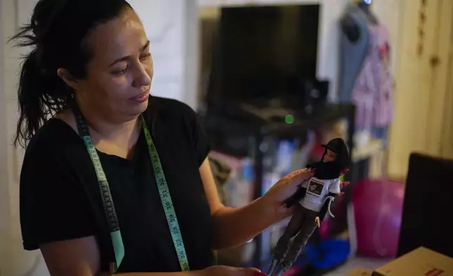 FILE - Delia Quiroa holds one of her Searching Mother costumed Barbie doll that has a picture of her missing brother Roberto with text that reads in Spanish; "Searching for you," in Mexico City, July 24, 2023. Quiroa is running for district judge in the Mexican state of Sinaloa in the upcoming June 1 judicial election. (AP Photo/Eduardo Verdugo, File)