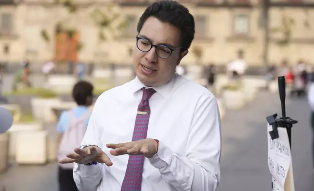 Supreme Court lawyer Mauricio Tapia Maltos campaigns ahead of the upcoming judicial elections, in the Zocalo, Mexico City’s main public square, Tuesday, April 1, 2025. Tapia Maltos is running for an administrative judge position. (AP Photo/Fernando Llano)
