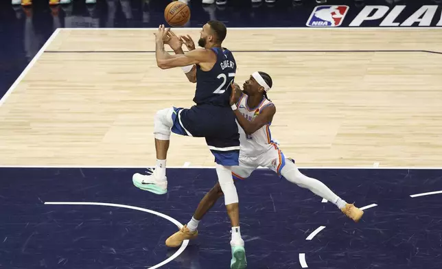 Oklahoma City Thunder guard Shai Gilgeous-Alexander (2) defends against Minnesota Timberwolves center Rudy Gobert (27) during the first half of Game 3 of the Western Conference finals of the NBA basketball playoffs, Saturday, May 24, 2025, in Minneapolis. (AP Photo/Matt Krohn)