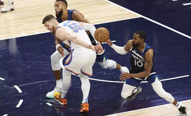 Oklahoma City Thunder center Isaiah Hartenstein (55), Minnesota Timberwolves center Rudy Gobert, and guard Mike Conley (10) reach for a loose ball during the first half of Game 3 of the Western Conference finals of the NBA basketball playoffs, Saturday, May 24, 2025, in Minneapolis. (AP Photo/Matt Krohn)