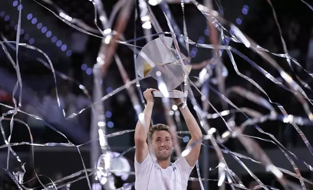 Norway's Casper Ruud holds the trophy after winning the Madrid Open tennis final in Madrid, Spain, Sunday, May 4, 2025. (AP Photo/Manu Fernandez)