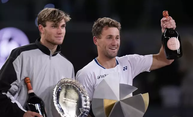 Britain's Jack Draper, left and the winner Norway's Casper Ruud stand on the podium after the Madrid Open tennis final in Madrid, Spain, Sunday, May 4, 2025. (AP Photo/Manu Fernandez)