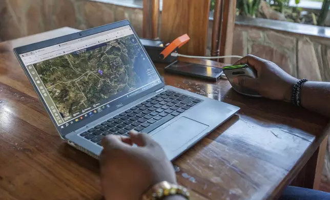 An official shows how the EarthRanger platform operates at Hwange National Park, Zimbabwe, Wednesday, April 30, 2025. (AP Photo/Aaron Ufumeli)