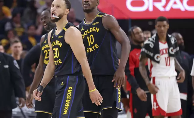 Golden State Warriors' Stephen Curry, Draymond Green and Jimmy Butler III head to the bench in fourth quarter of Game 6 of an NBA basketball first-round playoff series Friday, May 2, 2025, in San Francisco. (Scott Strazzante/San Francisco Chronicle via AP)