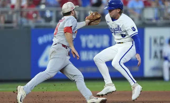 Kansas City Royals' Drew Waters, right, is tagged out by St. Louis Cardinals third baseman Nolan Arenado as he tried to advance to third for the second out in a double play hit into by Jonathan India during the eighth inning of a baseball game Saturday, May 17, 2025, in Kansas City, Mo. (AP Photo/Charlie Riedel)