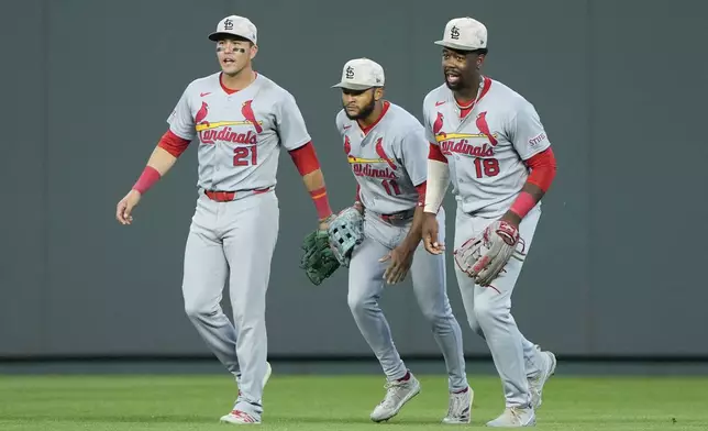 St. Louis Cardinals outfielders Lars Nootbaar (21), Victor Scott II (11) and Jordan Walker (18) celebrate after their baseball game against the Kansas City Royals, Saturday, May 17, 2025, in Kansas City, Mo. (AP Photo/Charlie Riedel)