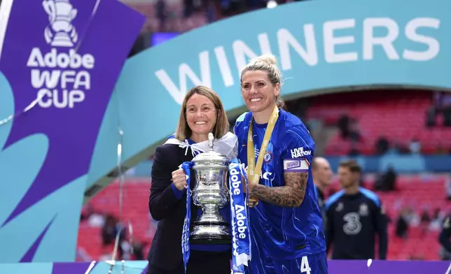 Chelsea manager Sonia Bompastor, left, and Millie Bright with the FA Cup trophy following victory in the English Women's FA Cup Final soccer match against Manchester United at Wembley Stadium, London, Sunday, May 18, 2025. (John Walton/PA via AP)