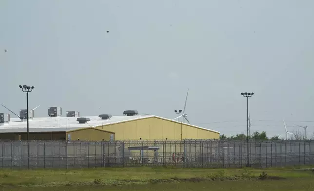 Detainees held at El Valle Detention Center in Raymondville, Texas are seen outside briefly, Thursday, May 1, 2025, after a federal judge in the district barred the Trump administration from deporting any Venezuelans from South Texas under the Alien Enemies Act, an 18th-century wartime law. (AP Photo/Valerie Gonzalez)