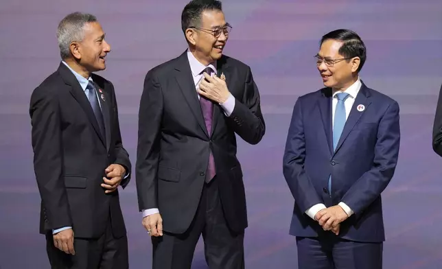 Singaporean Foreign Minister Vivian Balakrishnan, left, Thailand's Foreign Minister Maris Sangiampongsa, and Vietnam's Foreign Minister Bui Thanh Son, talk before a group photo at the Association of Southeast Asian Nations (ASEAN) Foreign Ministers' Meeting opening ceremony in Kuala Lumpur, Malaysia, Sunday, May 25, 2025.(AP Photo/Vincent Thian)