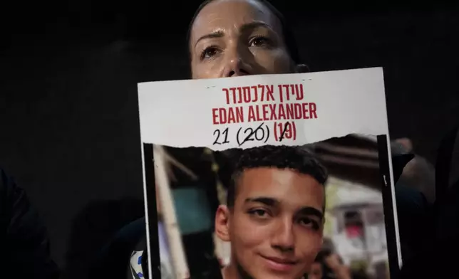 FILE - Yael Alexander holds a poster of her son, Edan, who was taken hostage by Hamas militants on Oct. 7, 2023, during a weekly rally for families of hostages held in the Gaza Strip and their supporters, in Tel Aviv, Israel, Feb. 22, 2025. (AP Photo/Maya Alleruzzo, File)