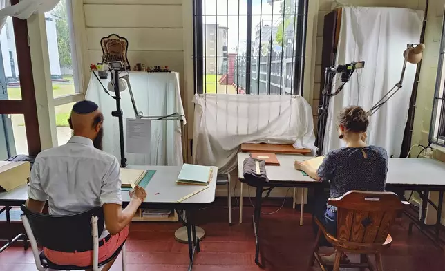 Ronnay Reeder, left, and Rosa de Jong scan images in Paramaribo, Suriname, Friday, May 2, 2025. (AP Photo/Oscar Keur)