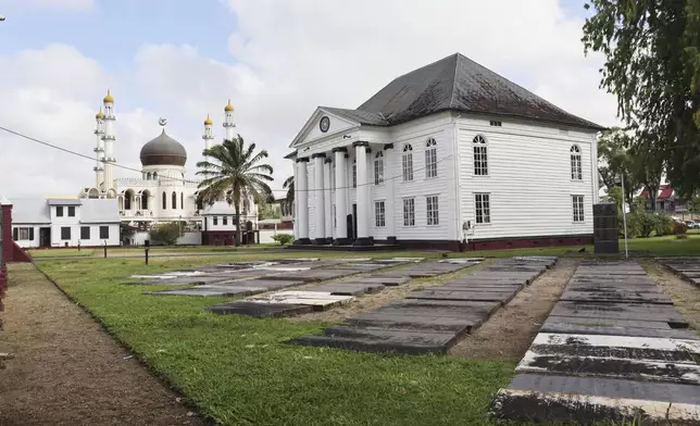 Exterior view of the synagoge, right, in Paramaribo, Suriname, Wednesday, April 30, 2025. (AP Photo/Rosa de Jong)