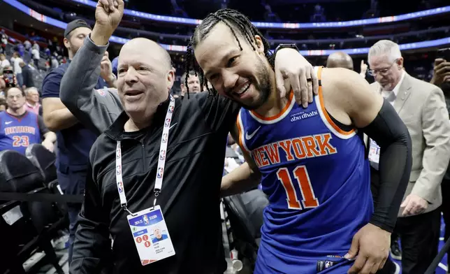 President of the New York Knicks Leon Rose, left, hugs guard Jalen Brunson (11) as they leave the court following a Game 6 win in an NBA basketball first-round playoff series against the Detroit Pistons, Thursday, May 1, 2025, in Detroit. (AP Photo/Duane Burleson)