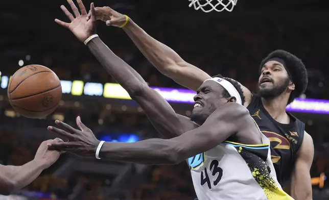 Indiana Pacers forward Pascal Siakam (43) loses the ball as he is defended by Cleveland Cavaliers center Jarrett Allen, right, during the second half of Game 3 in the Eastern Conference semifinals of the NBA basketball playoffs in Indianapolis, Friday, May 9, 2025. (AP Photo/Michael Conroy)