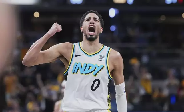 Indiana Pacers guard Tyrese Haliburton (0) celebrates in the first half of Game 4 against the Cleveland Cavaliers in the Eastern Conference semifinals of the NBA basketball playoffs in Indianapolis, Sunday, May 11, 2025. (AP Photo/Michael Conroy)