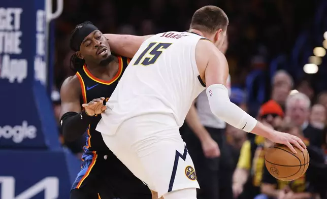 Oklahoma City Thunder guard Luguentz Dort (5) takes an elbow to the back of the head from Denver Nuggets' Nikola Jokic (15) in the second half of Game 1 of an NBA basketball second-round playoff series Monday, May 5, 2025, in Oklahoma City. (AP Photo/Nate Billings)